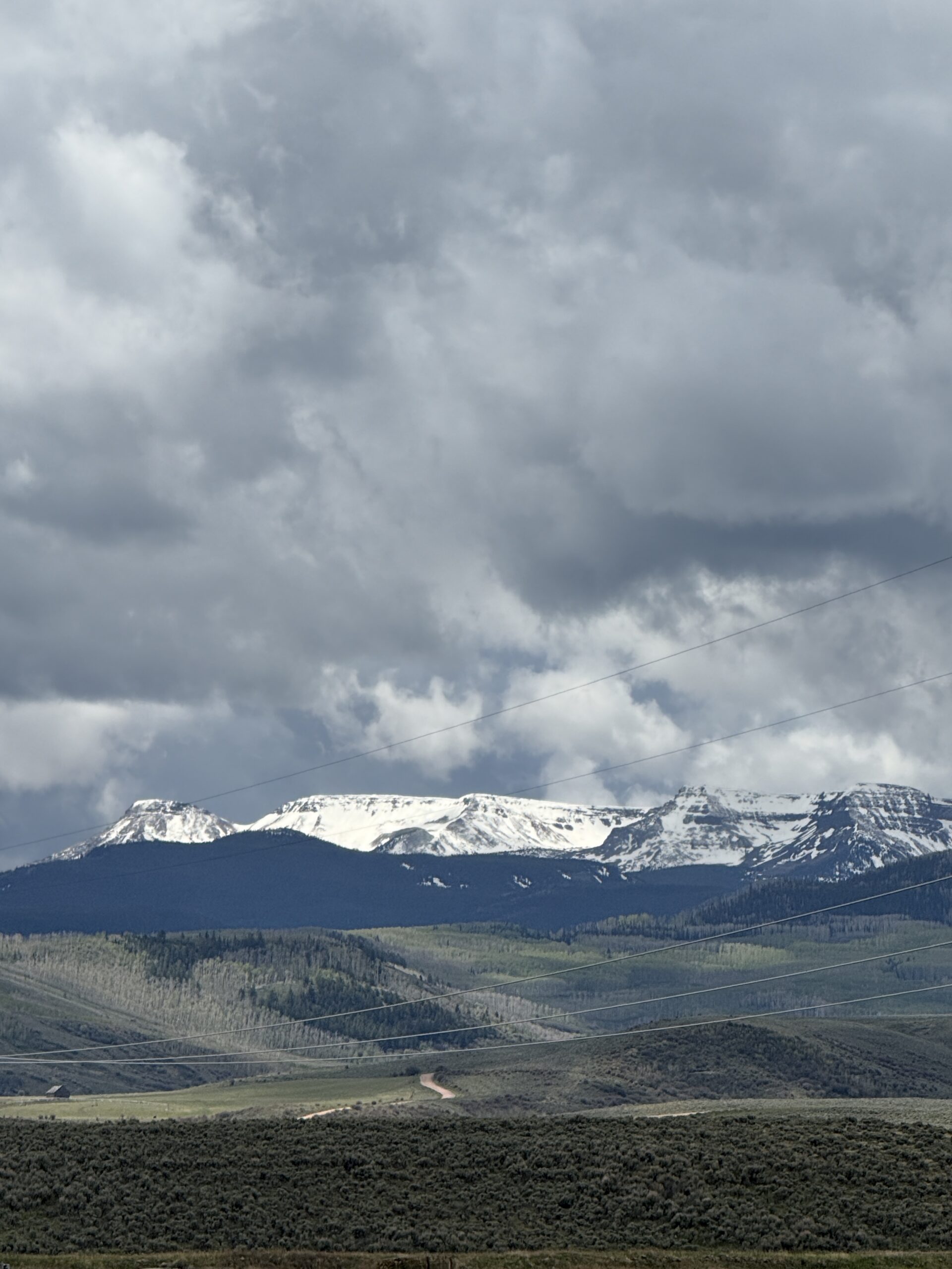 snow covered mountains with a cloudy backdrop.